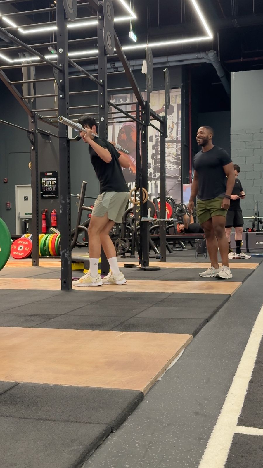 Client front squat coached by a personal trainer in Dubai
