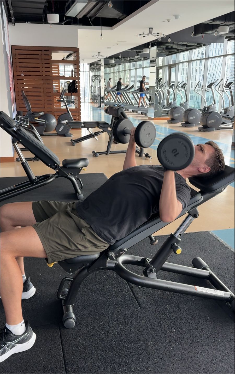 Dumbbell incline press in a Dubai residence gym